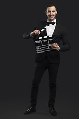 Image showing Business man holding a clapboard