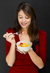 Image showing Woman eating a fruit salad