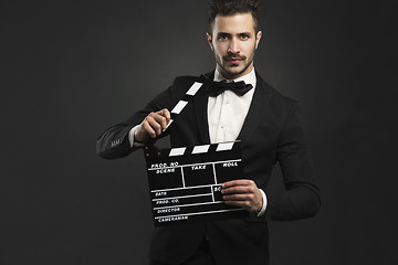 Image showing Man holding a clapboard