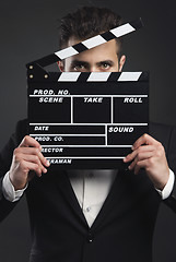 Image showing Business man holding a clapboard