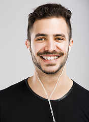 Image showing Man smiling and listen music