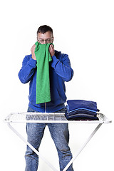 Image showing man smells laundry