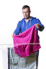 Image showing man putting laundry