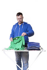 Image showing man putting laundry