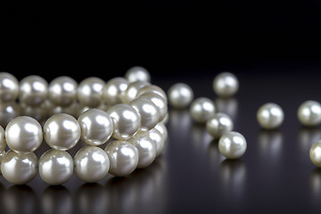 Image showing white pearls necklace on black  