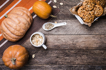 Image showing Pumpkins, seeds and  cookies with nuts  on wood in Rustic style