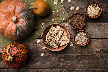 Image showing Pumpkins with cookies and seeds on wood in Rustic style. 