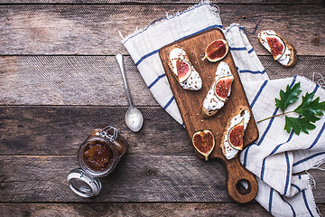 Image showing Bruschetta with figs on chopping board in rustic style