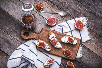 Image showing Tasty Bruschetta with jam and figs on napkin in rustic style