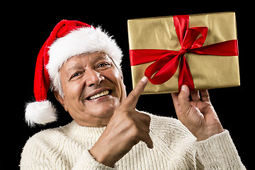 Image showing Avid Aged Man Pointing At Golden Wrapped Present