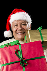 Image showing Aged Gentleman Peering Across Three Wrapped Gifts