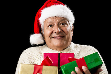 Image showing Puzzled Old Gentleman Carrying Three Wrapped Gifts