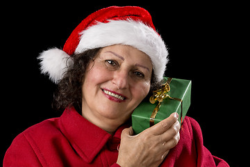 Image showing Senior Lady with Santa Claus Hat and Wrapped Gift
