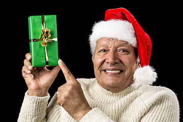 Image showing Gleeful Aged Man Pointing At Raised Green Present