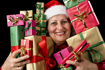 Image showing Delighted Aged Woman Embosoming Wrapped Presents
