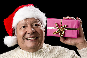 Image showing Excited Old Man With Santa Cap And Magenta Gift