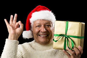 Image showing Grinning Male Senior With Gift Gesturing OK Sign