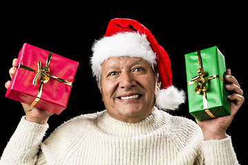 Image showing Poignant Aged Man Showing Red And Green Xmas Gifts