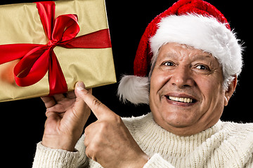 Image showing Excited Aged Man Pointing At Golden Gift In Hand