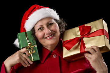 Image showing Smiling Lady with Golden and Green Christmas Gifts
