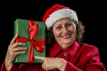 Image showing Happy Female Pensioner Pointing at Wrapped Gift
