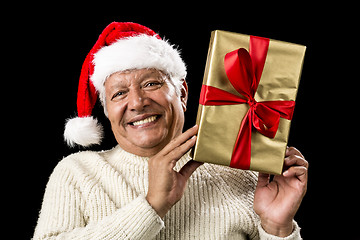 Image showing Smiling Old Man With Golden Gift Isolated On Black