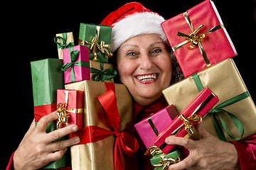 Image showing Cheerful Female Senior Embosoming Wrapped Gifts
