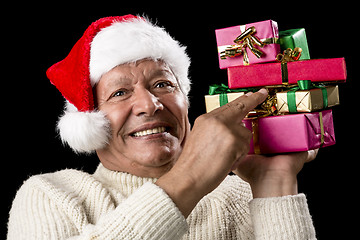 Image showing Male Senior Firmly Pointing At Six Wrapped Gifts
