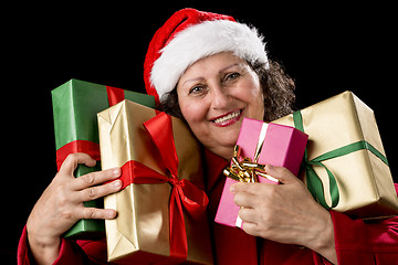 Image showing Smiling Aged Woman Embracing Four Wrapped Gifts
