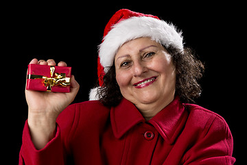 Image showing Happy Aged Woman Presenting Red Wrapped Xmas Gift
