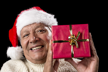 Image showing Smiling Old Man With Red Wrapped Christmas Gift