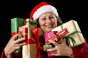 Image showing Joyful Senior Woman Hugging Eight Wrapped Gifts
