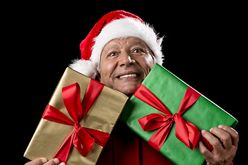 Image showing Old Man In Red Gaping Across Two Wrapped Gifts