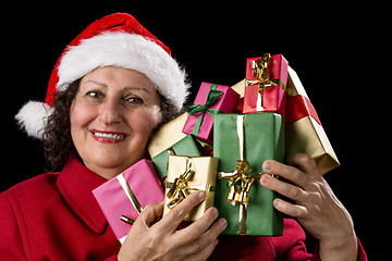Image showing Smiling Old Woman is Holding Seven Wrapped Gifts

