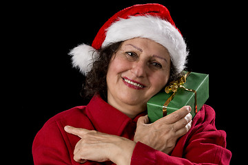 Image showing Smiling Female Senior with Red Santa Claus Cap
