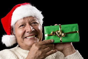 Image showing Elderly Man with Santa Cap And Green Wrapped Gift