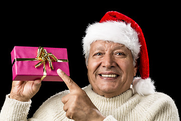 Image showing Joyous Old Man Pointing At Magenta Wrapped Gift