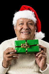 Image showing Smiling Old Man Handing Over A Wrapped Green Gift