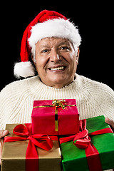 Image showing Aged Man Offering Three Wrapped Christmas Presents