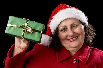 Image showing Elderly Woman Holding up a Green Wrapped Xmas Gift
