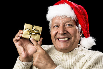 Image showing Joyful Old Man Gesturing At Wrapped Golden Gift