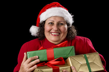 Image showing Delighted Elderly Woman Hugging Three Wrapped Gifts
