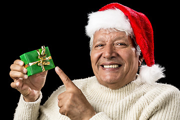 Image showing Cheerful Old Man Pointing At Green Wrapped Gift