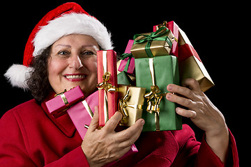 Image showing Happy Female Senior Lifting Many Wrapped Presents
