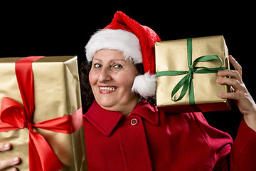 Image showing Happy Old Lady in Red with Wrapped Golden Gifts
