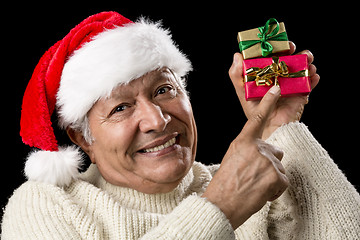 Image showing Smiling Senior Pointing At Two Wrapped Xmas Gifts