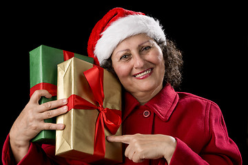 Image showing Aged Woman Pointing at Two Gifts, Golden and Green
