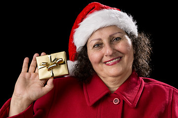 Image showing Smiling Old Lady Shows Golden Wrapped Christmas Gift
