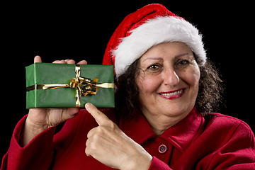 Image showing Female Senior Pointing at Green Wrapped Present
