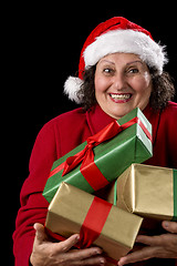 Image showing Cheerful Old Lady Offering Three Wrapped Gifts 
